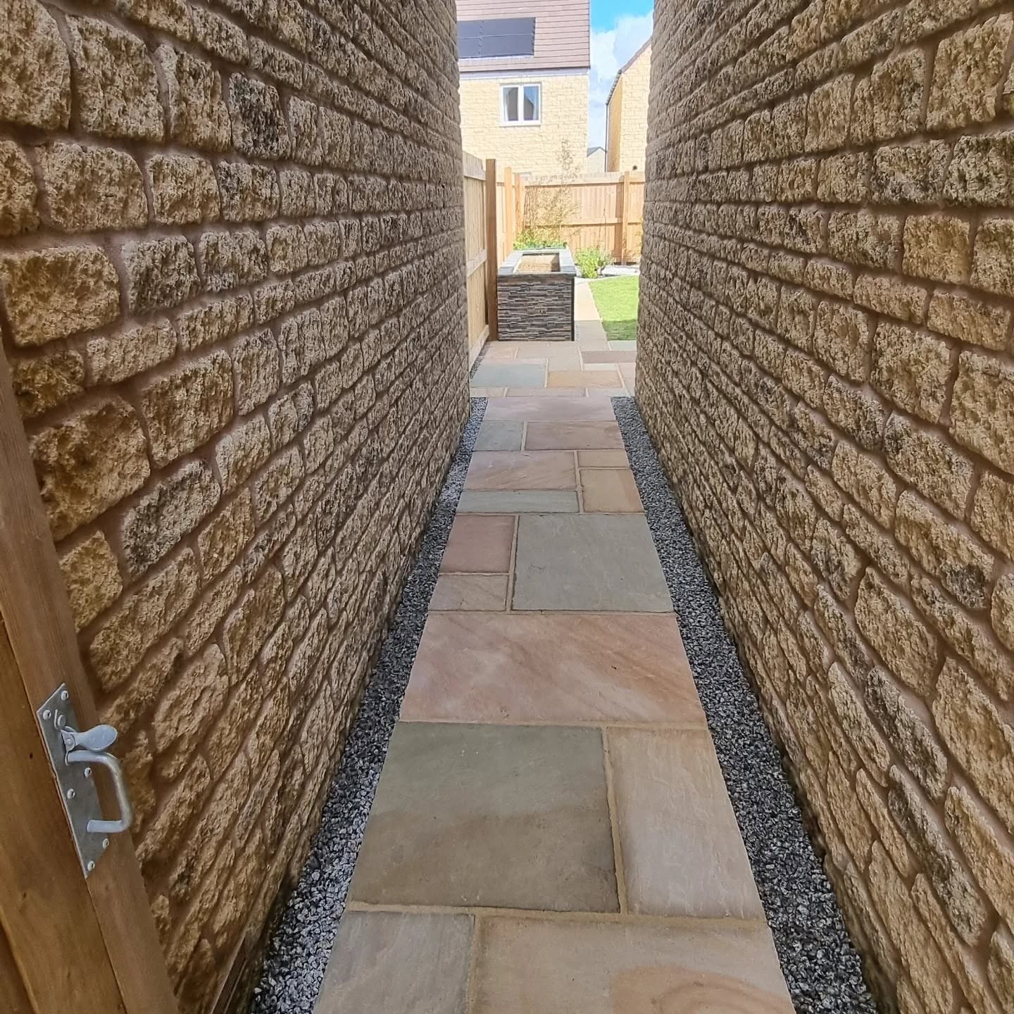 Sandstone path down a narrow passage between stone walls