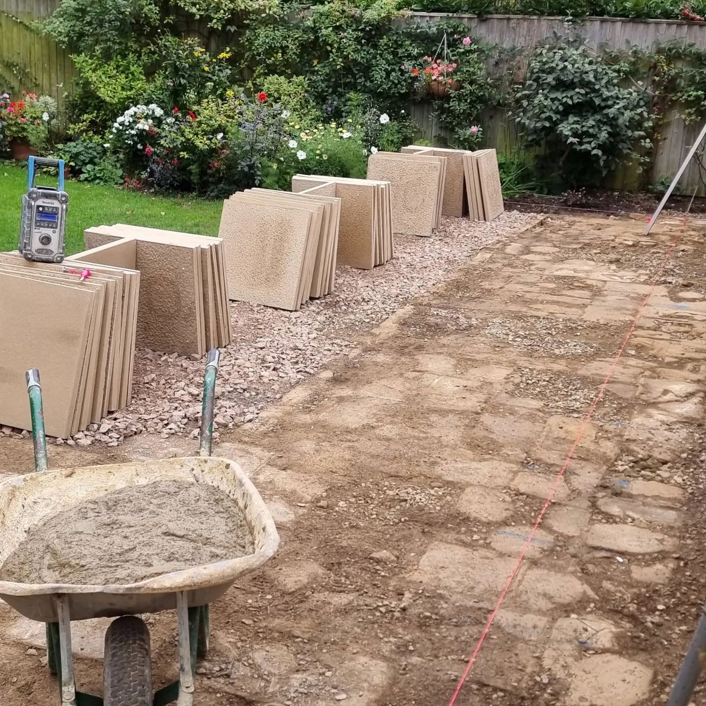 New sandstone slabs stacked on site and the base prepared