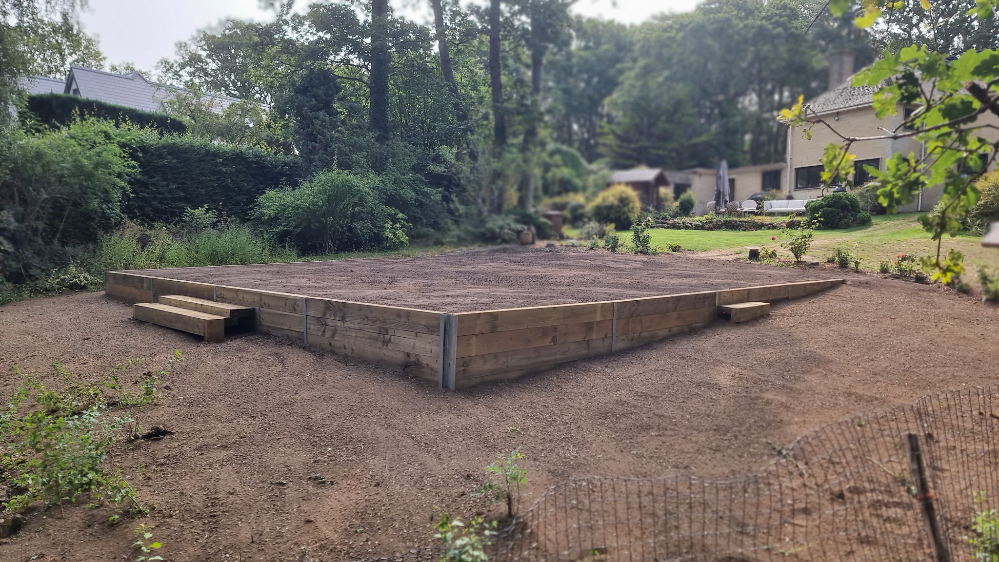 Raised timber sleeper platform with sleeper steps on levelled ground