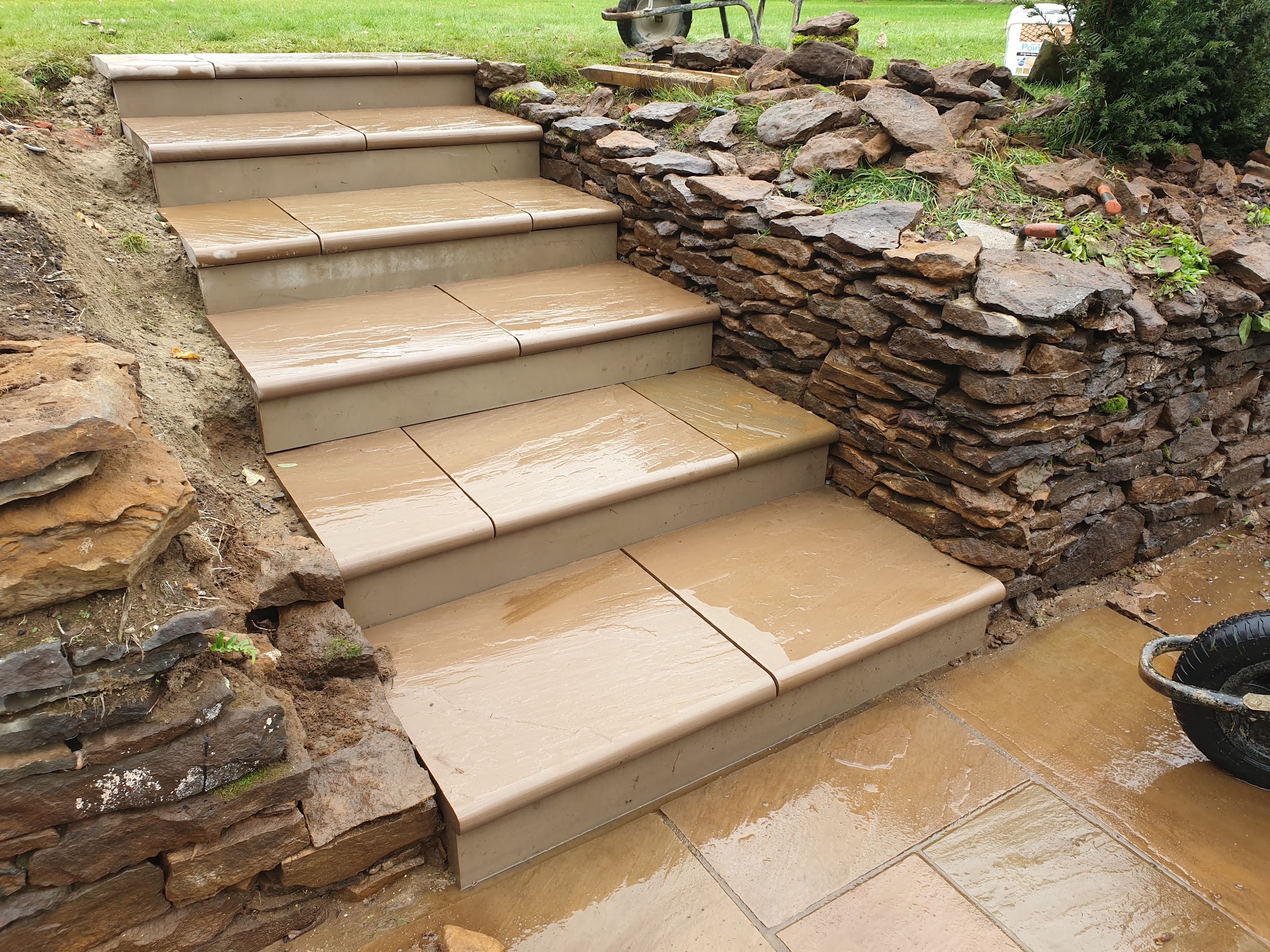 Sandstone steps beside a dry stone retaining wall